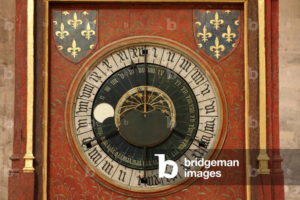 15th century astronomical clock - Bourges - Astronomical clock - 15th century - Bourges - France - Bourges - Cathedrale Saint Etienne. Astronomical clock of Jean Fusoris 15th century, 1424. The astronomical dial shows the average time (outer circle, graduated in 24 hours), the phases of the Moon and the date. On the inner circle, the time of sunrise and sunset in Bourges and the height of the sun relative to the horizon, as well as its position in front of the zodiac. Astronomical clock - 15th century by Jean Fusoris. Saint Etienne cathedral, Bourges, France