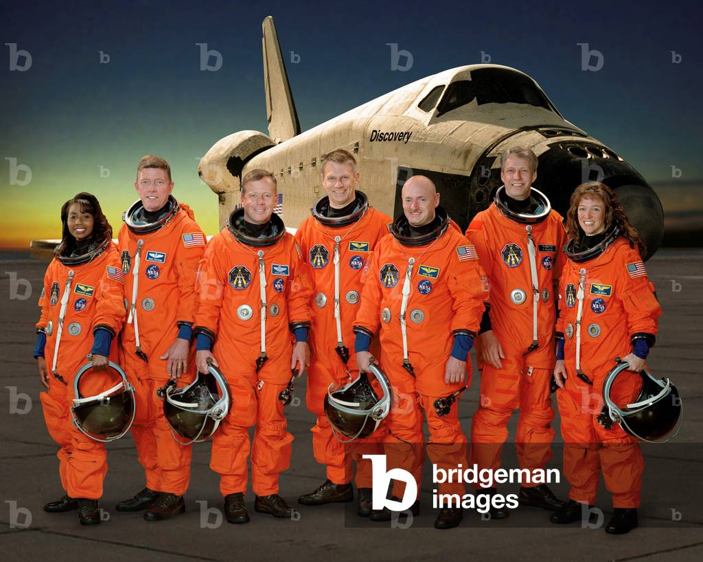 STS Mission Crew - 121 - From left to right astronauts: Stephanie Wilson, Michael Fossum, Steven Lindsey, Piers Sellers, Mark Kelly, Thomas Reiter, and Lisa Nowak. Space Shuttle Discovery took this crew into space from 4 to 17 July 2006. Mission STS-12