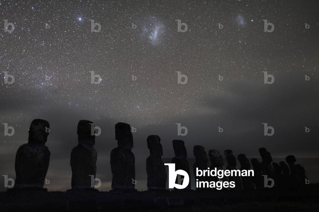 Starry sky above Moais on Easter island - The Clouds of Magellan and the Star Canopus above the Moais of Easter Island. Ahu Tongariki. September 2009. Magellanic Clouds with the bright star Canopus above Moais on Easter island. Ahu Tongariki. September 2009