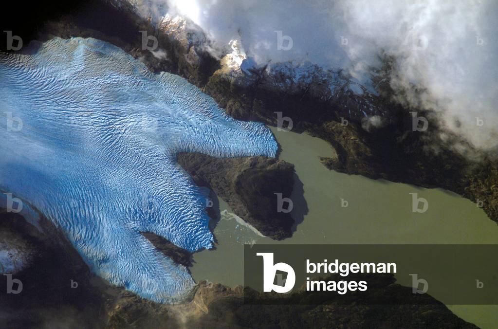 Grey Glacier, Chile - The Grey Glacier in the Torres del Paine National Park in Chile, observed from the International Space Station in June 2007. The Southern Patagonian Icefield of Chile and Argentina hosts several spectacular glaciers - including Grey Glacier located in the Torres del Paine National Park in Chile. This glacier, which in 1996 had a measured total area of 270 square kilometers and a length of 28 kilometers (104 square miles in area, 17 miles long), begins in the Patagonian Andes Mountains to the west and terminates in three distinct lobes into Grey Lake. The image is a photograph taken by an astronaut aboard the International Space Station in june 2007, and it captures a striking blue coloration of the glacier. The coloring is due to the ice's absorption of red wavelengths of light and scattering of blue wavelengths of light as it is transmitted through the ice