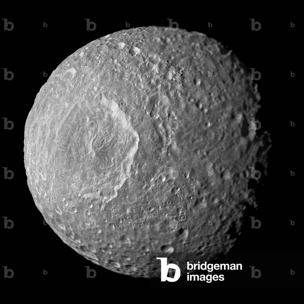 Mimas, satellite of Saturn, seen by the Cassini probe on 13/02/2010 - Saturn's moon Mimas seen by Cassini spacecraft - February 13 2010 - The Mimas satellite photographed by the Cassini probe on 13 February 2010 has a distance of 16,000 km from the satellite. Mimas is about 400 km in diameter. In the centre left, the large impact crater Herschel, 130 km wide. Relatively dark regions below bright crater walls and streaks on some of the walls are seen in this mosaic of Saturn's moon Mimas, created from images taken by Nasa's Cassini spacecraft during its closest flyby of the moon. The crater floors and surroundings are about 20 percent darker than the steep crater walls in this view. Mimas 'original surface, like the surfaces of most of the other major Saturnian moons without atmospheres, is not pure ice but contains some dark impurities. The relatively dark markings appear along the lower portion of the walls of Herschel Crater (130 kilometers, 80 miles wide) and some of the smaller craters and are marked in green in the annotated version of the image. Cassini scientists interpret this darkening as evidence for the gradual concentration of impurities from evaporating icy materials in areas where the dark impurities slide slowly down the crater wall. There, the bright ice is baked away by the sun and the vacuum of space. At Herschel, the edge where the darker regions contact the crater floor is interrupted by an extensive hummocky area. Scientists believe the hummocky texture came from the flow of melted ice that occurred during the impact that created the crater. That melt filled the bottom of the crater around the central peak. Dark streaks are seen making their way down the sides of some craters and often originated from pockets of dark contaminants embedded just below the rim of the crater wall. The pockets themselves likely represent small, pre - existing, dark - floored craters that were buried by the blanket of material thrown out from the newer im