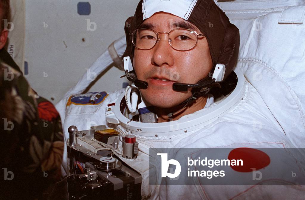 Takao Doi in the Columbia shuttle before extravehicular exit - Astronaut Takao Doi prepares for an EVA. 1997 - Takao Doi (NASDA) is preparing for an outing in space.Nov/Dec 1997. Takao Doi prepares for one of two Extravehicular Activities (EVA) in the Airlock Module of the Earth - orbiting Space Shuttle Columbia. Takao Doi, an international astronaut stationed at Johnson Space Center (JSC), represents Japan's National Space Development Agency (NASDA). Nov/Dec 1997