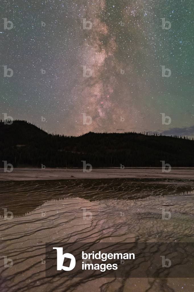 Lactee Lane on Grand Prismatic Spring - Yellowstone - The Milky Way in Yellowstone - Stars reflection on wet soil around hot spring. The Milky Way reflects in the wet soil surrounding Grand Prismatic Spring in Yellowstone National Park