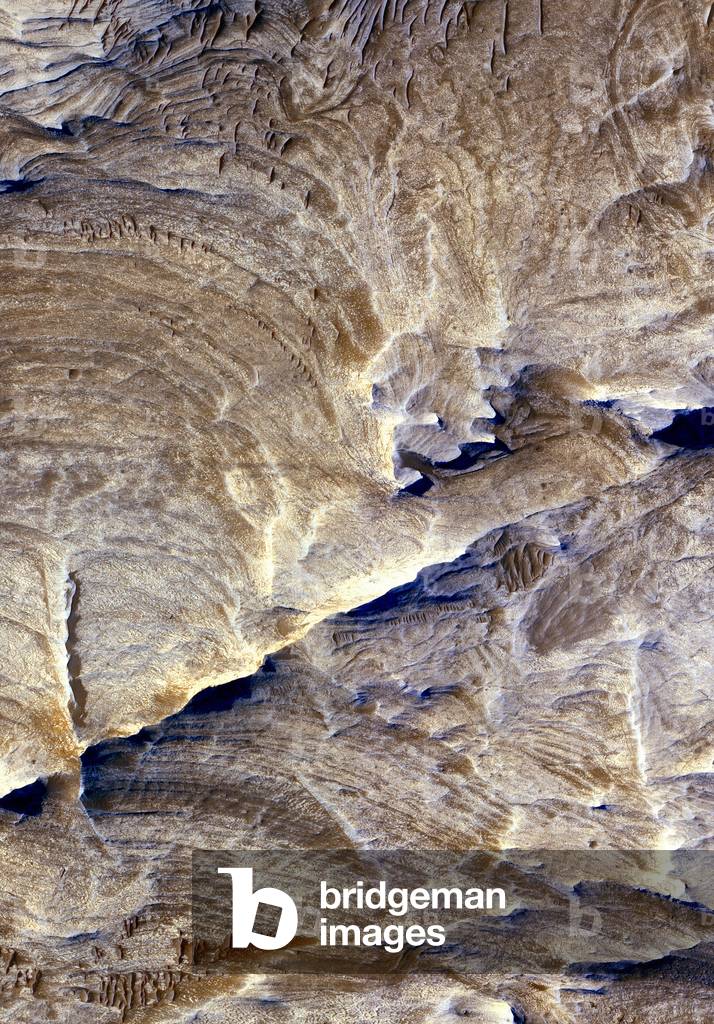 March: Detail of the region of Candor Chasma. - Detail of the region of Candor Chasma, in Valles Marineris, obtained in September 2006 by the HIRISE camera on board the Mars Reconnaissance orbiter probe. The white cretes visible in the lower part of the image would have been formed by the passage of water through the basement of the planet millions of years ago