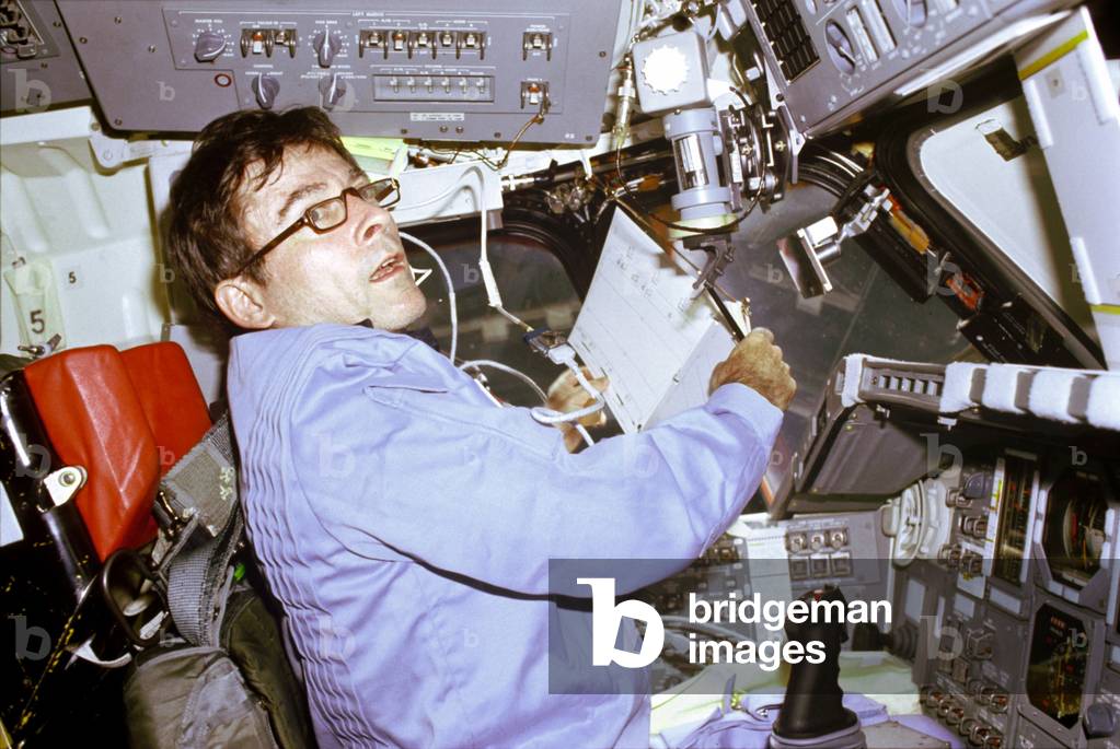 J. Young in Shuttle 04/1981 - STS-1: John Young in Columbia - John Young records flight data on Shuttle Columbia STS-1 mission. April 1981. John Young, STS - 1 mission Commander, prepares to log flight - relevant data in a loose - leaf flight activities notebook onboard the Space Shuttle Columbia. Apr 1981