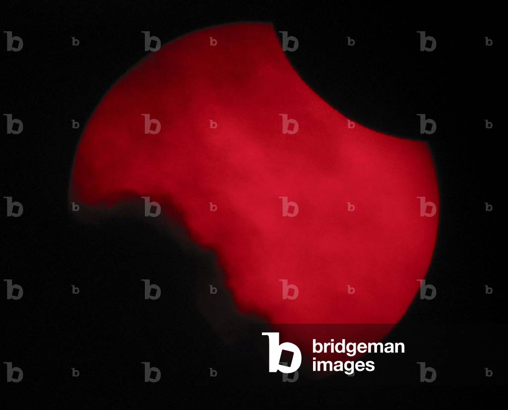 Annular Eclipse of Sun - 3 October 2005 - Spain - Annular solar eclipse - Spain - October 3 2005 - Beginning of the eclipse photographed between clouds, with an H - alpha filter. Beginning of the eclipse seen between clouds, with an H - alpha filter