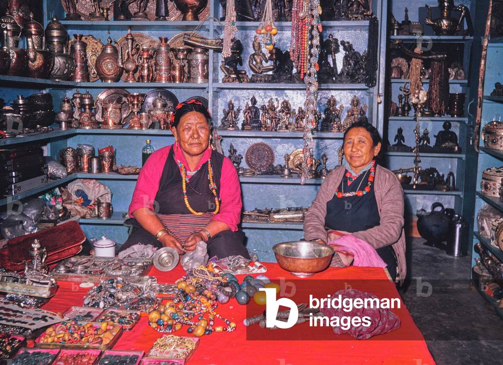 Tibetan refugees earn a living by selling jewellery, beads and trinkets in a wooden hut in Delhi, India (photo)