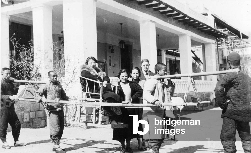 Woman carried in a litter, 1936 (b/w photo)