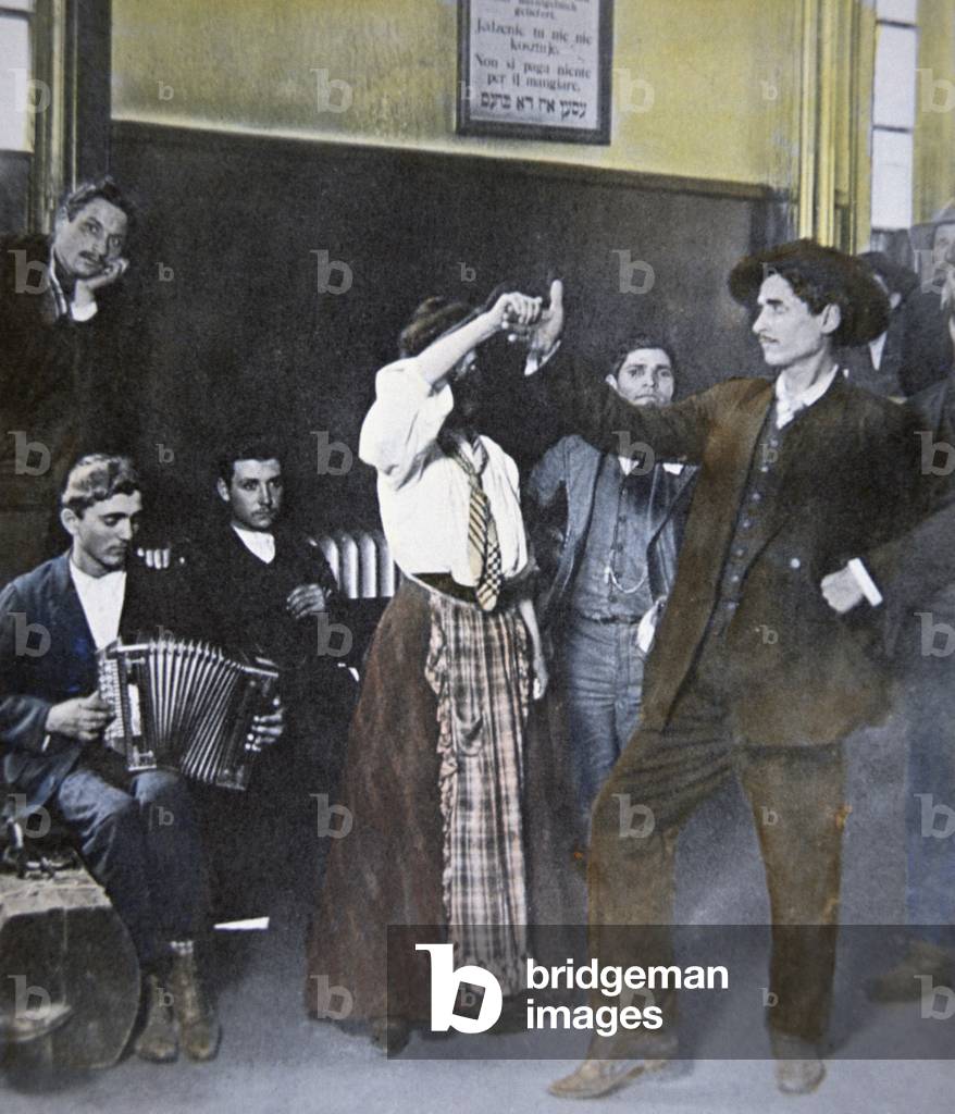 Immigrants folk dancing on Ellis Island, New York, 1907 (colour litho)