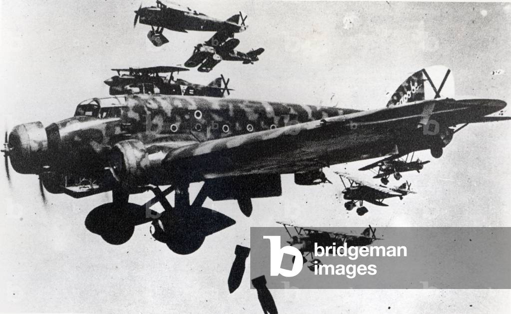 Italian aircraft (CR 32) dropping bombs in Spain during the Spanish Civil War (1936-39) (b/w photo)