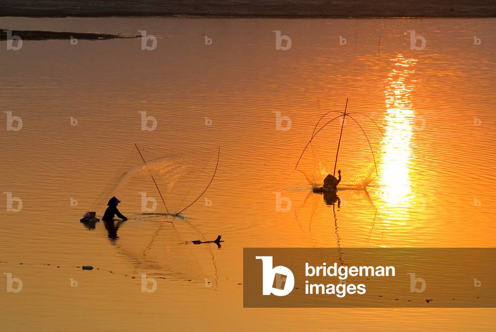 Two fishermen casting nets in Mekong at sunset (photo)