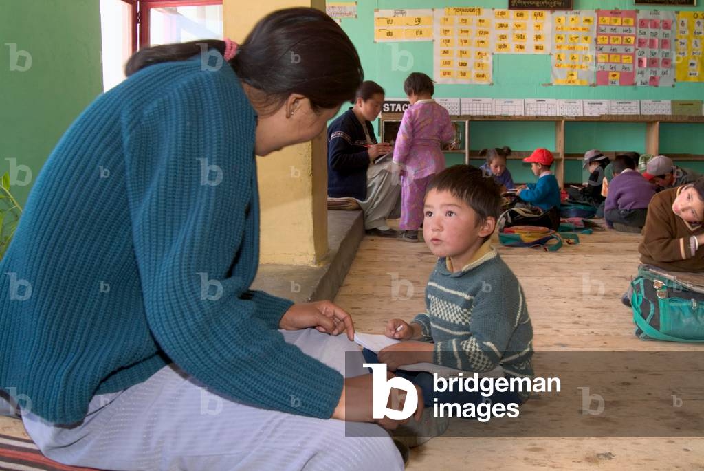 Ladakhi  primary schoolboy in one-to-one session with teacher in village school Manjushri Model School, Sakti, Ladakh, Himalayas, Jammu and Kashmir, India (photo)