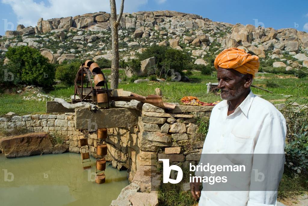 91-year old hill farmer next to persian wheel which he built 65years ago (photo)
