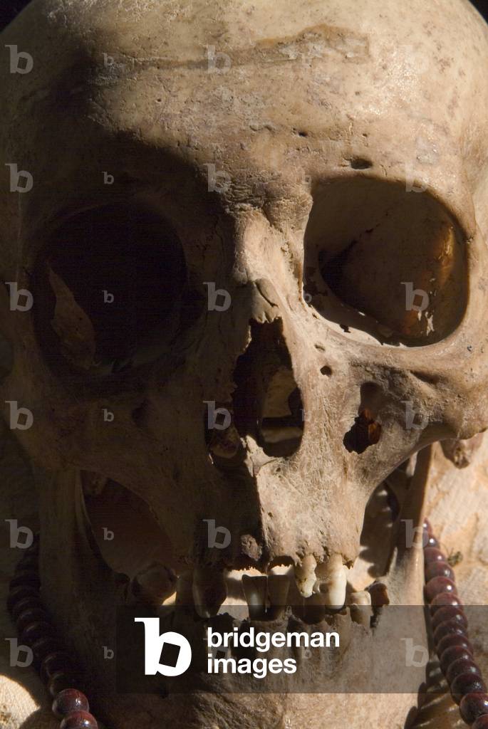 Human skull with mala, prayer beads, on a plinth in the shrine room of a Buddhist monastery (photo)