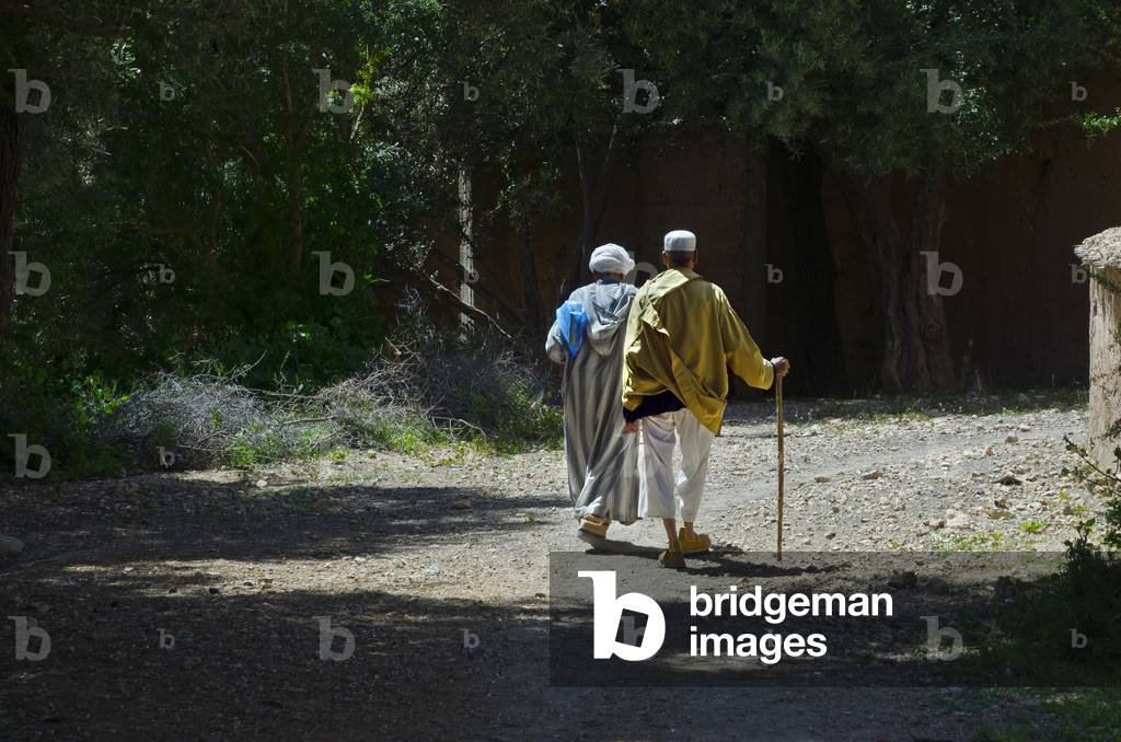 Two Berber men walking through mountain village, Tazglimt, High Atlas Mountains, Taroudant Province, Morocco (photo)