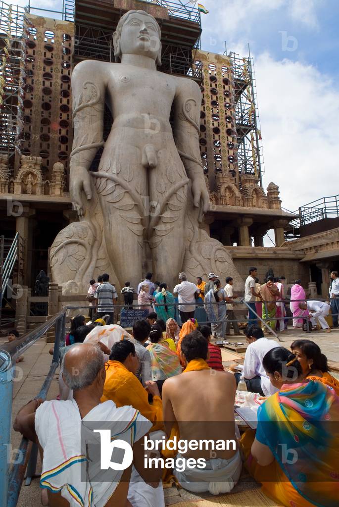 Jain devotees chanting at the feet of the Gomateshwara sculpture on Indragiri Hill (photo)
