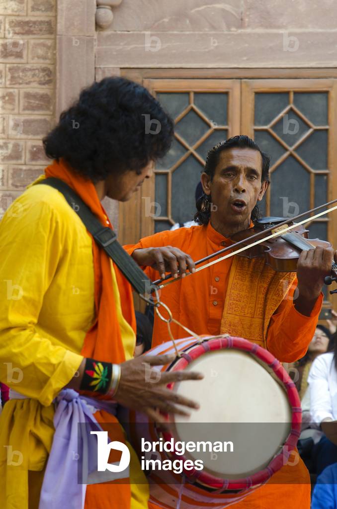 Violinist & singer and drummer performing as part of 