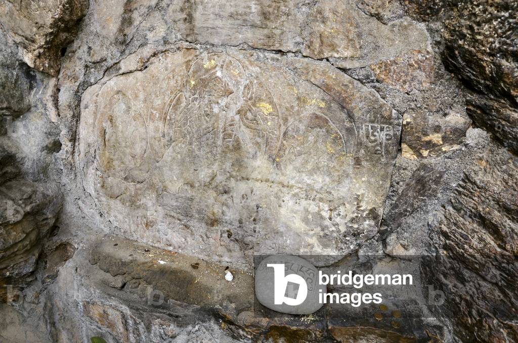 Asura Cave, ancient slab with engraving of Padmasambhava and Om Mani stone, Pharping, Kathmandu Valley, Nepal (photo)
