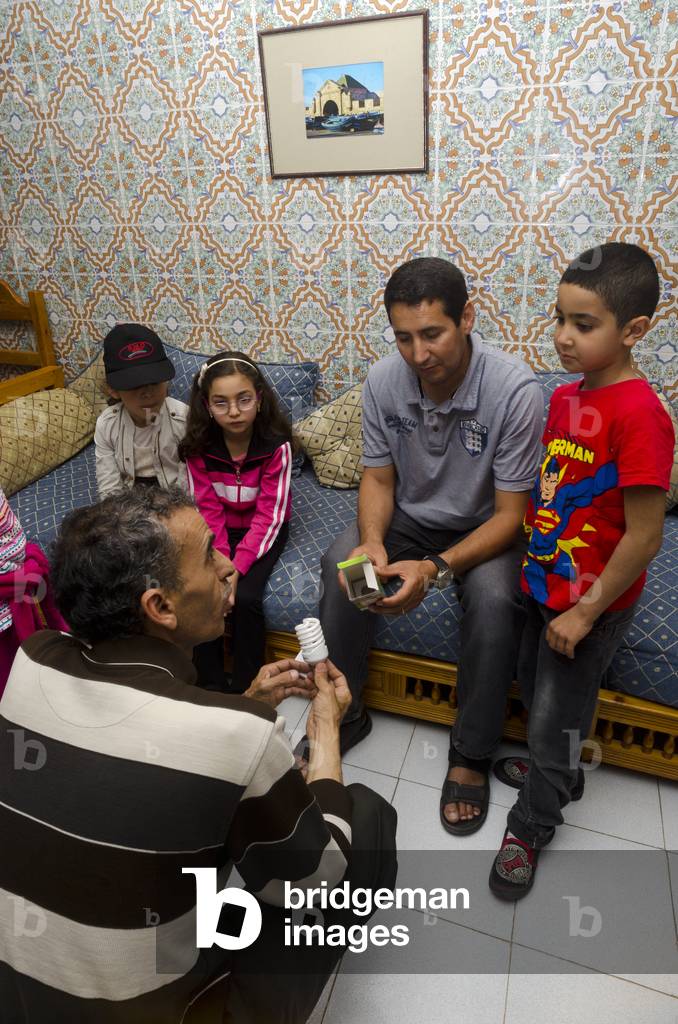 Environmentalist demonstrating and explaining low energy lightbulbs to a group of  children, Taroudant, Souss-Massa-Draa Region, Morocco (photo)