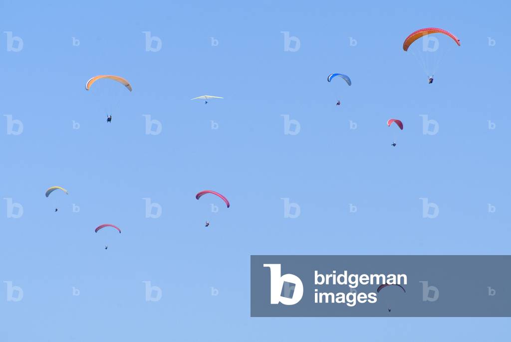 Paragliders in blue sky, Rhossili Downs, Gower, South Wales, UK (photo)