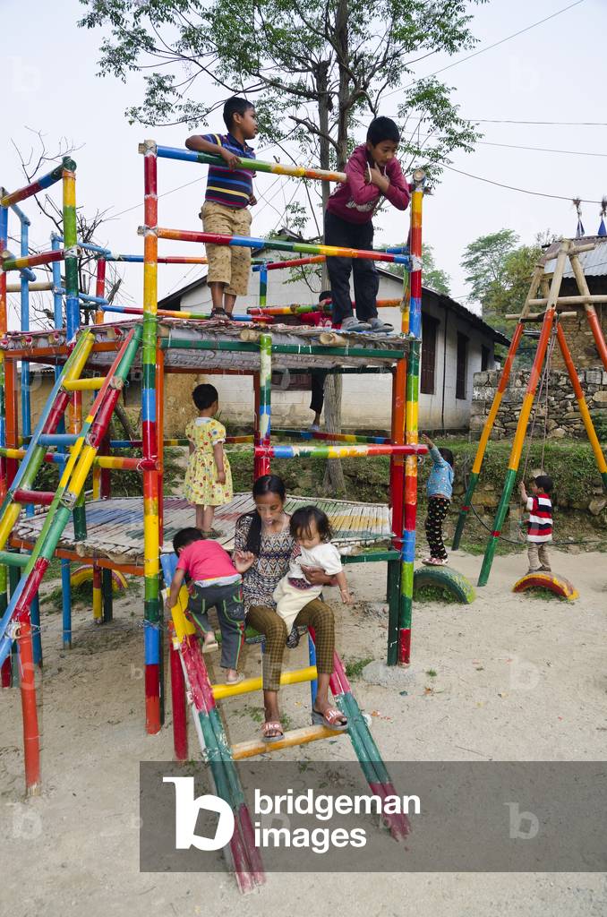 Children on playground climbing frame, Kahare, Chalnakhel, Kathmandu Valley, Nepal (photo)