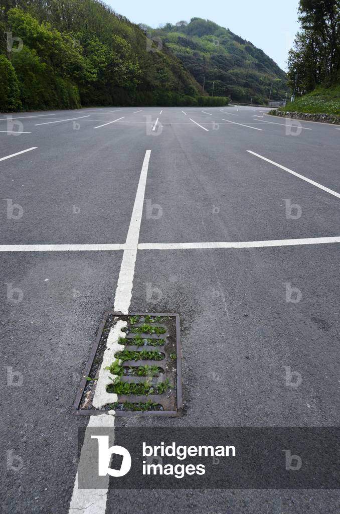 Closed car park with blocked, grassy drain in countryside during Corona virus pandemic, Gower, South Wales, United Kingdom, 2020 (photo)