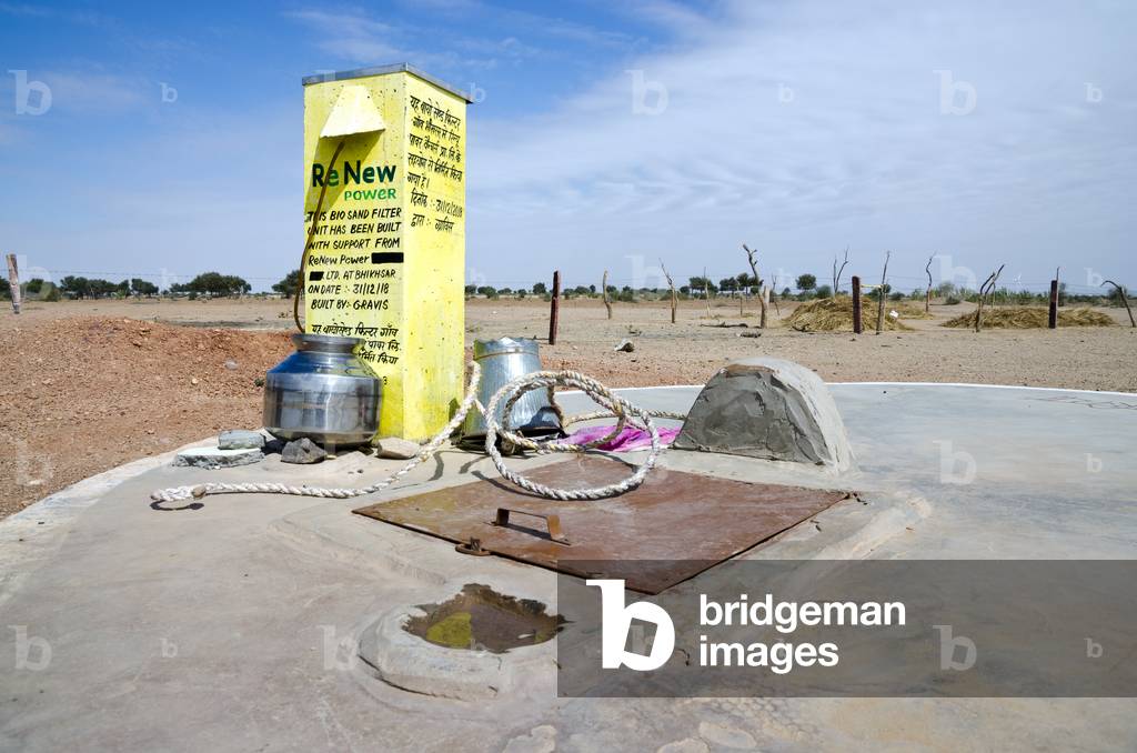 Rainwater harvesting: Biosand filter on top of underground drinking water storage tank in a desert hamlet, Thar Desert, Rajasthan, India (photo)