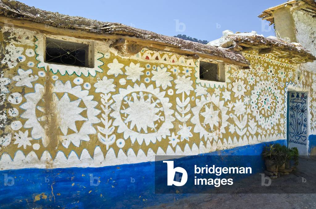 Symbolically  ('Baraka') painted house facade in Berber village in High Atlas mountains, Tizgui, Mentaga Valley,  Taroudant Province,  Morocco (photo)