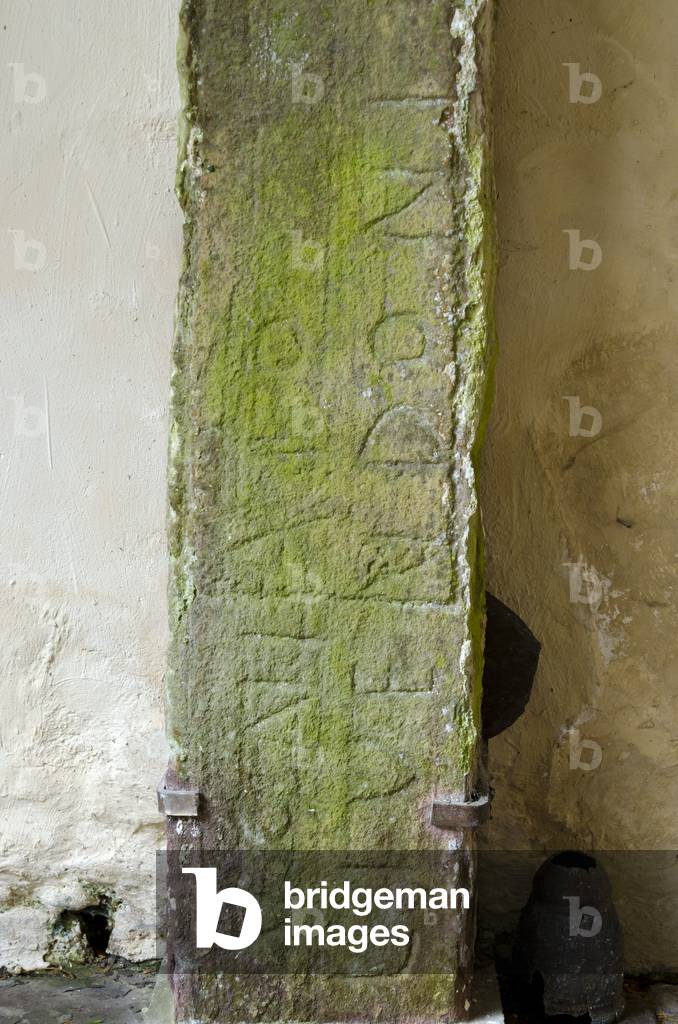 Roman tomb stone with traces of Ogham  script and later Celtic ring-cross mounted in church porch, St. Cynog's Church, Defynnog, Powys, South Wales, United Kingdom (photo)
