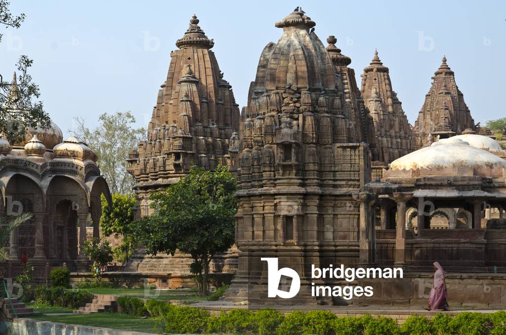 Mandore Gardens, Mandore: Elaborate sandstone memorials in evening light, Indian woman walking past,
Jodhpur, Rajasthan, India (photo)