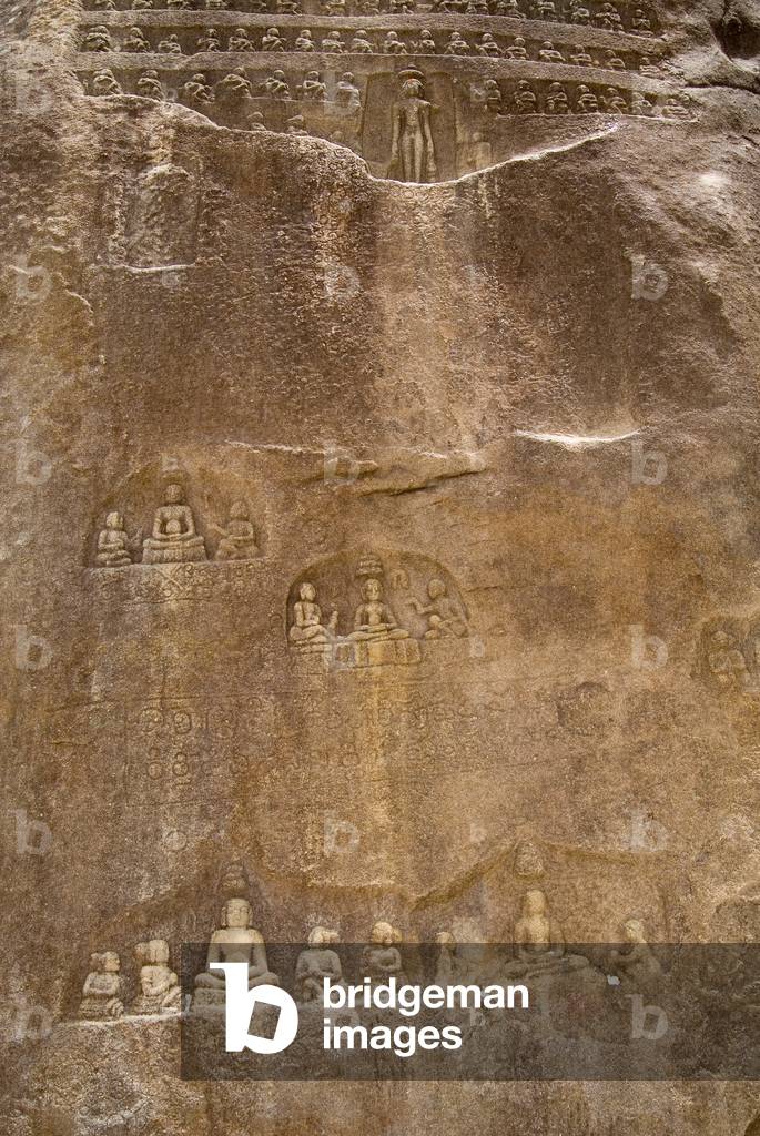 Rock carvings of numerous ascetics in meditation positions on Indragiri Hill (photo)