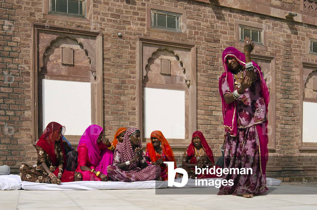Group of Rajasthani women performing traditional chants and dance accompanying themselves with hand-clapping,
Mehrangarh Fort, Jodhpur, Rajasthan, India, (photo)