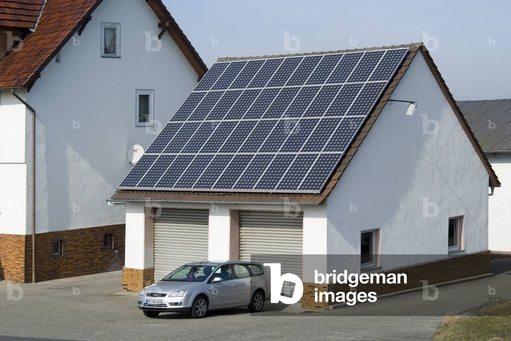 Solar PV panels on garage roof of rural house, Albshausen, Hesse, Germany (photo)