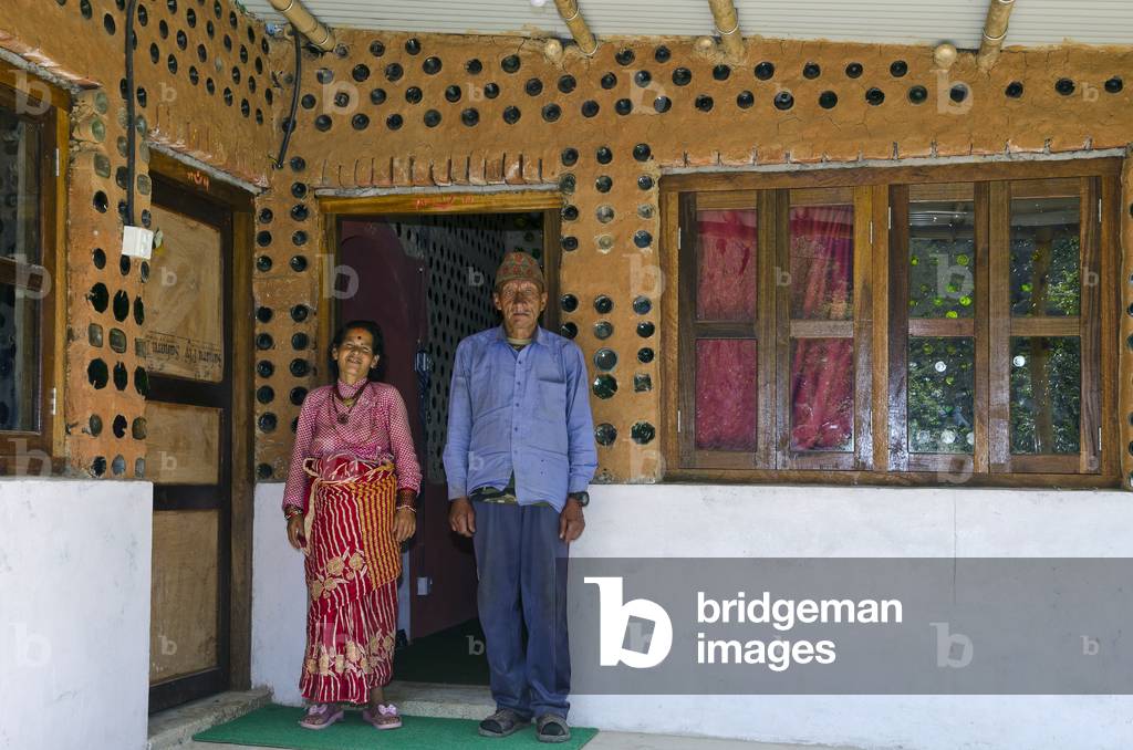 Nepali village couple outside their Bottle House built after 2015 earthquake, Gwaldaha, Dakshinkali, Kathmandu Valley, Nepal (photo)