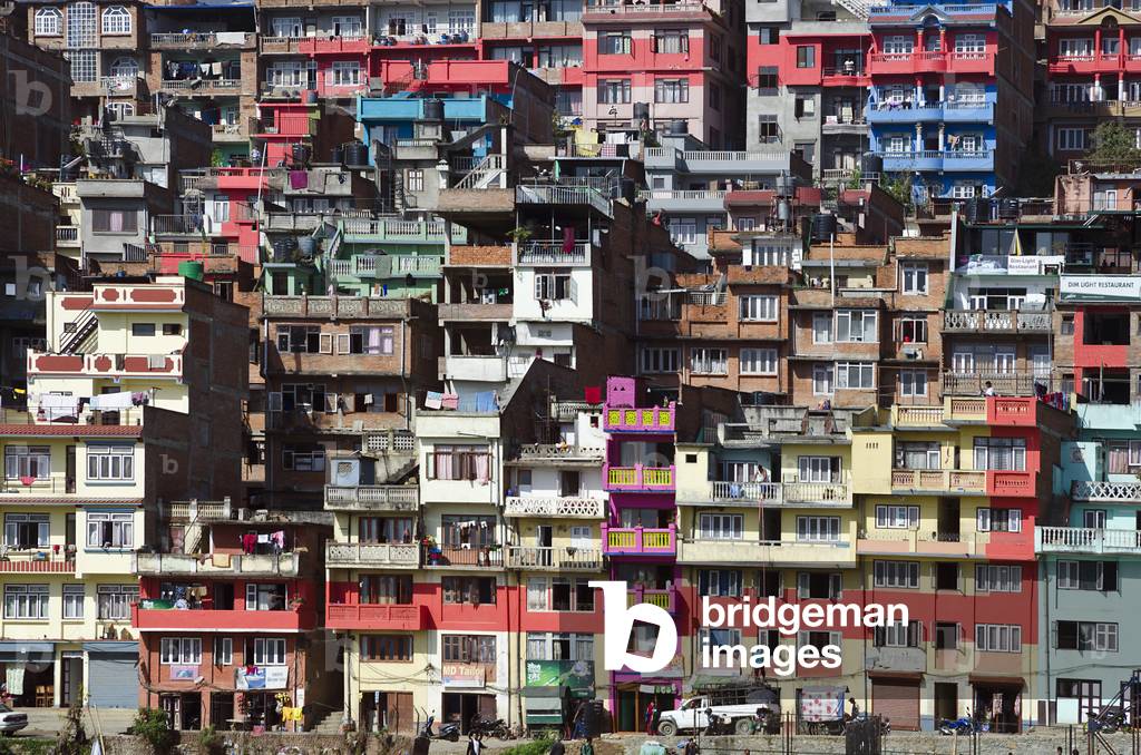 Colourful cluster of dense, multi-storied urban housing on a hillside, 
Kirtipur, Kathmandu Valley, Nepal (photo)