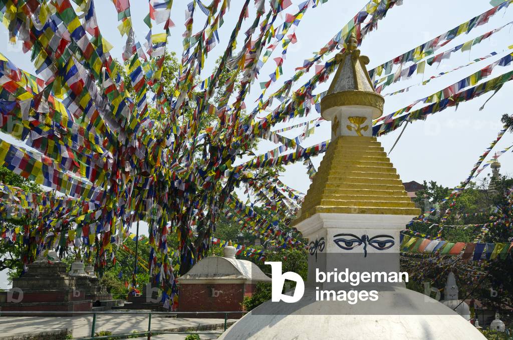 Swayambhu (aka. Monkey Temple) complex: A small stupa with Buddha Eyes under a canopy of Tibetan Buddhist prayer flags, Kathmandu, Nepal (photo)