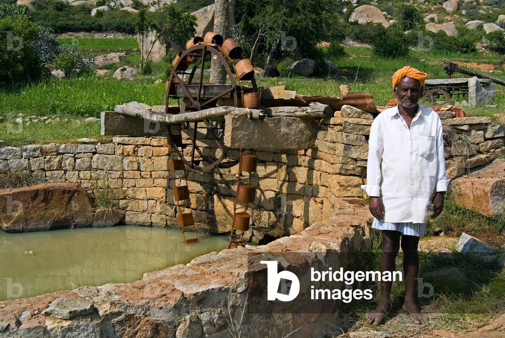 91-year old hill farmer next to Persian wheel which he built 65 years ago