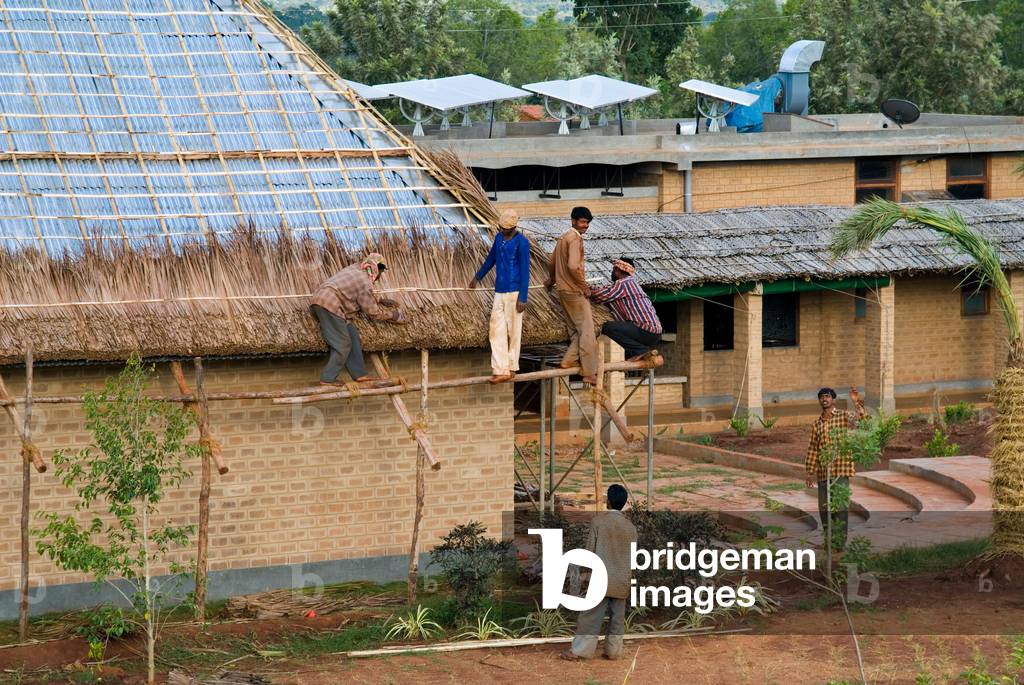 Traditional craftsmen thatching a cottage in an eco-friendly lifestyle resort, Our Native Village in Hessarghatta, Bangalore Rural District, Karnataka, India

