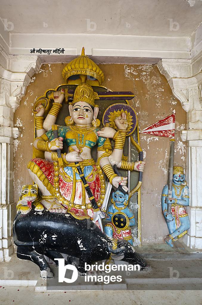 Hindu sculpture of Mahishasura Madhini carved out of the natural rock wall behind, coated with plaster and painted, 18th century Hall of Heroes and Divinities,
Mandore, Jodhpur, Rajasthan, India (photo)