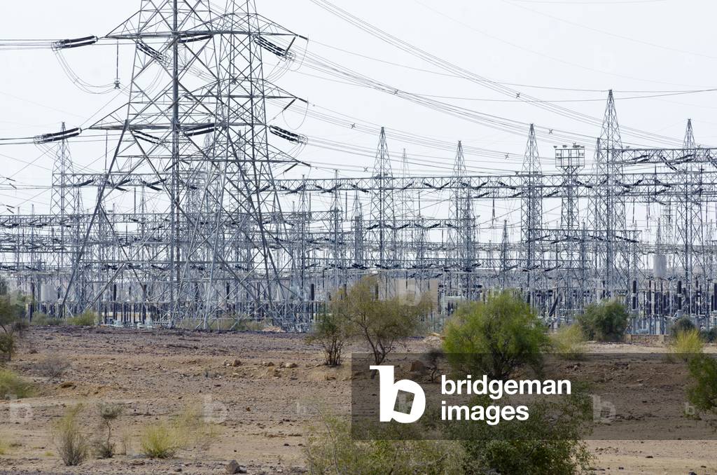 Pylons and power lines at electrical substation for wind farm in Thar Desert, between Jaisalmer and Barmer, Rajasthan, India (photo)