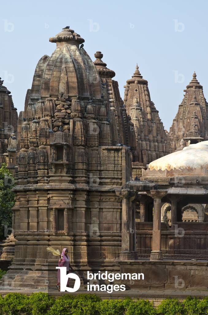 Mandore Gardens, Mandore: Elaborate sandstone memorials in evening light, Indian woman walking past,
Jodhpur, Rajasthan, India (photo)