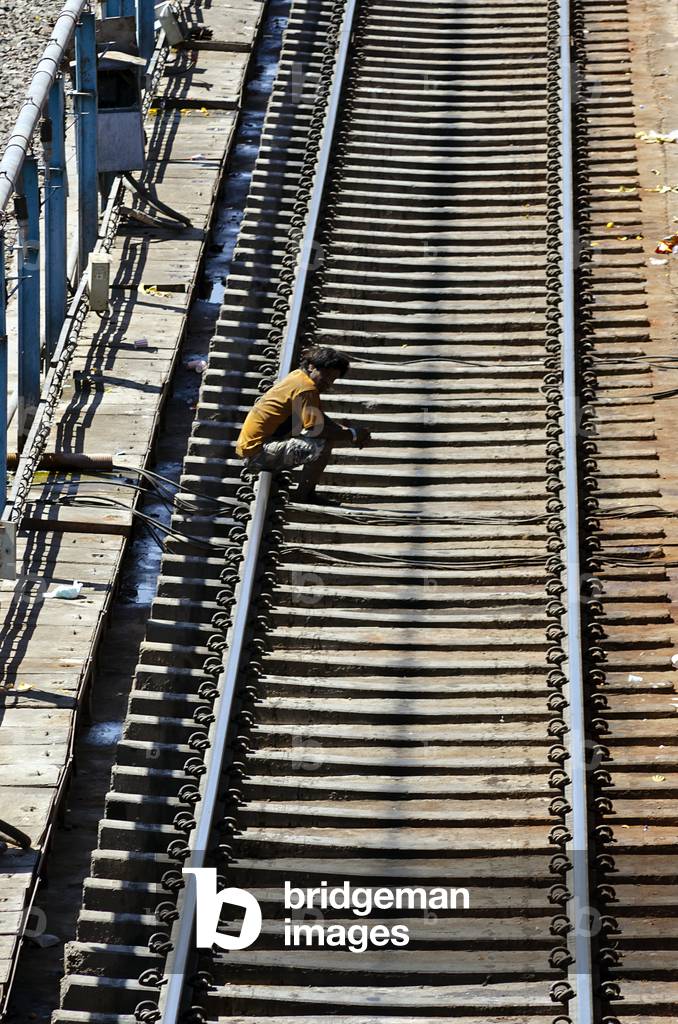 Man sitting on rail tracks at Jodhpur Railway Station,
Rajasthan, India (photo)