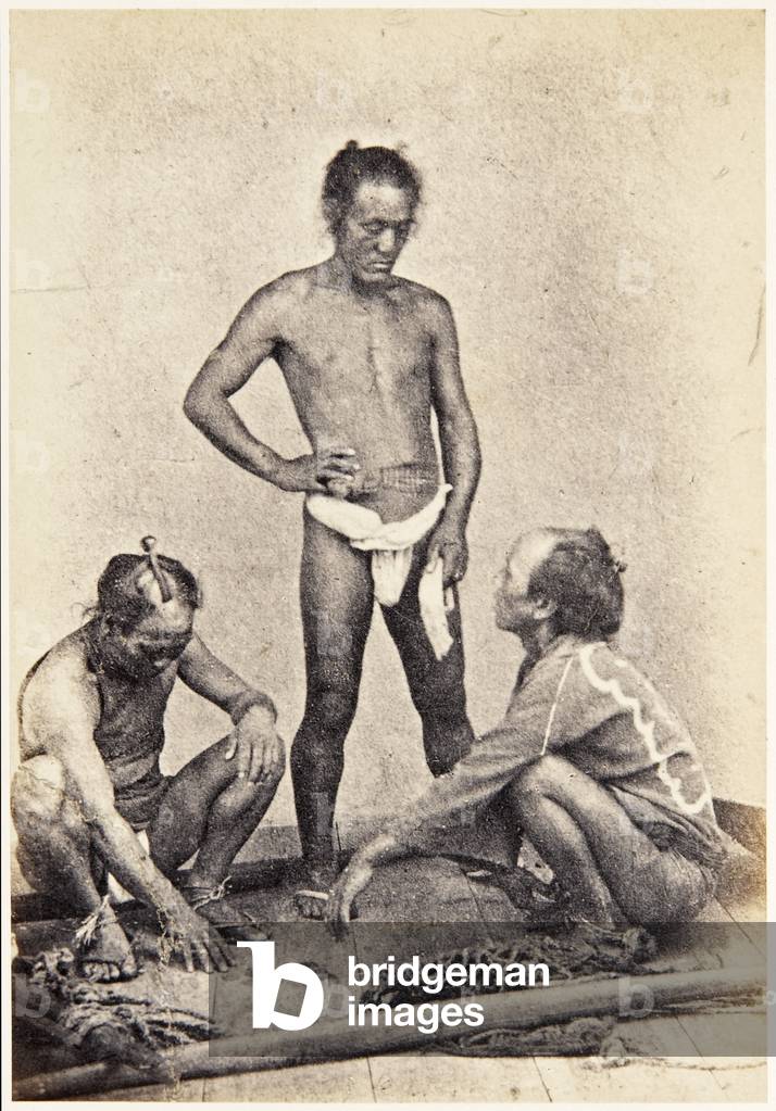 Group portrait of three Japanese men, workers, standing, wearing clothing typical of their trade, c.1860 (albumen print)