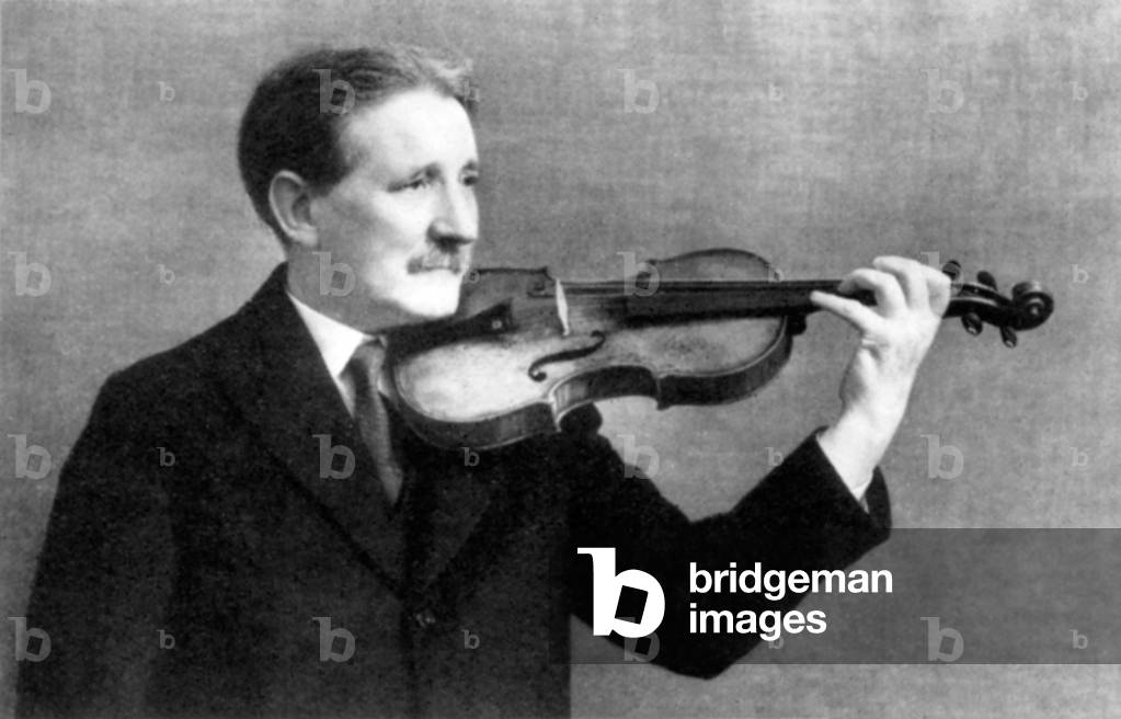 W.H. Reed holding a violin., English violinist and composer (1876-1942)