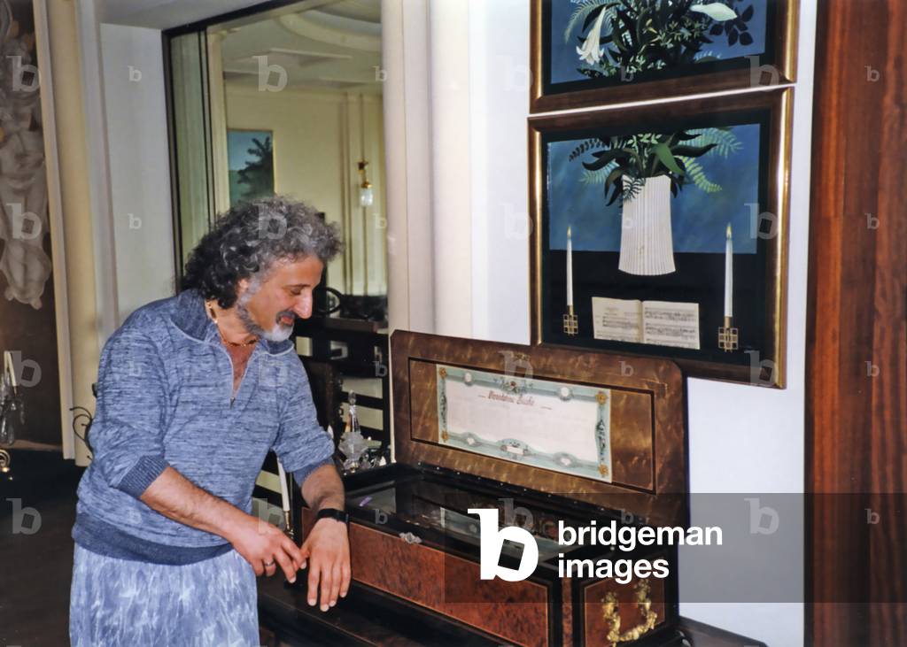 Mischa Maisky, cellist, at home with musical box, photograph by Tully Potter