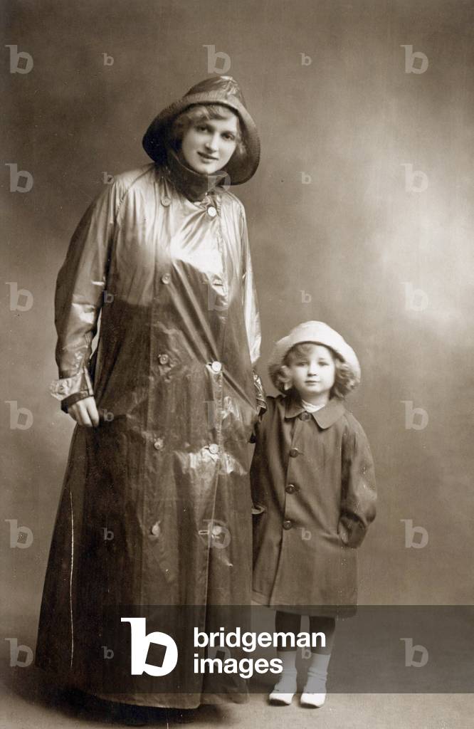 A woman wearing a raincoat withher little girl, Postcard, c. 1910
