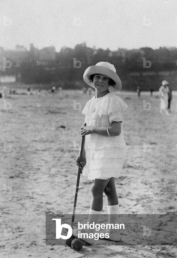 Young girl playing croquet c. 1920