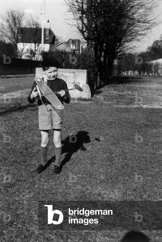 Boy with a plane toy, France, 1936 (b/w photo)