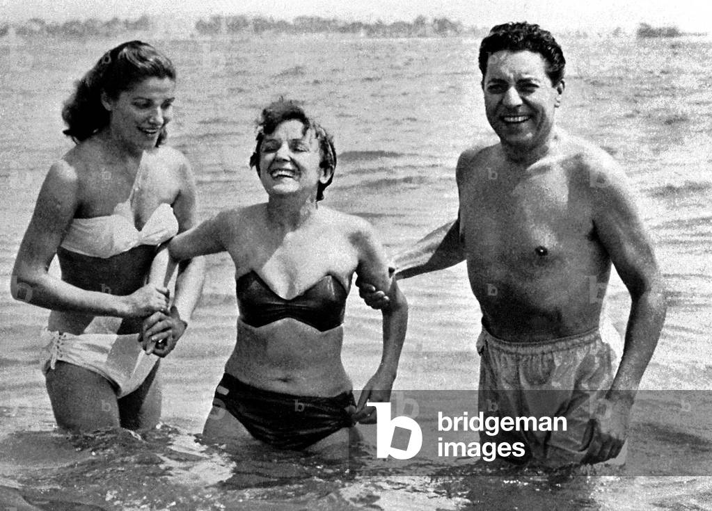In august 1952, in Cannes, France, Edith Piaf and Jacques Pills with their secretary having a swim