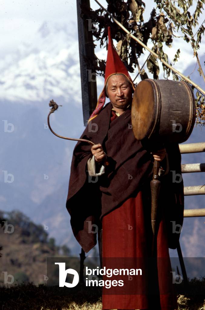 Shinglay Lama beating on large drum near Singhik, Sikkim 1969 January.
